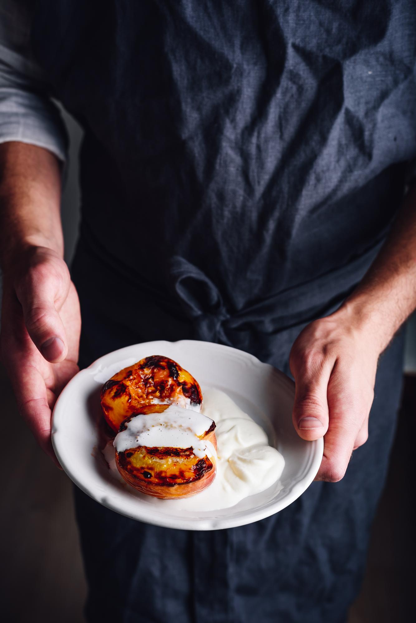 Chef preparing plated dish in warm kitchen